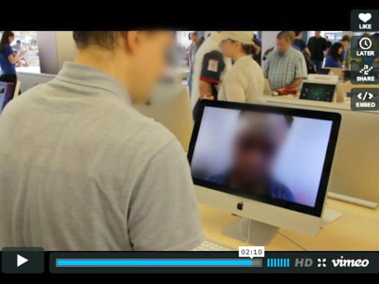 This still was taken from Kyle McDonald's video documenting his art project. As it includes photos taken in Apple Stores without permission, we have blurred all subjects' faces.